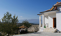 Villa Lyoudmila Earth Building Workshop in Bulgaria View of Villa Lyoudmila and garden with mountains in the background